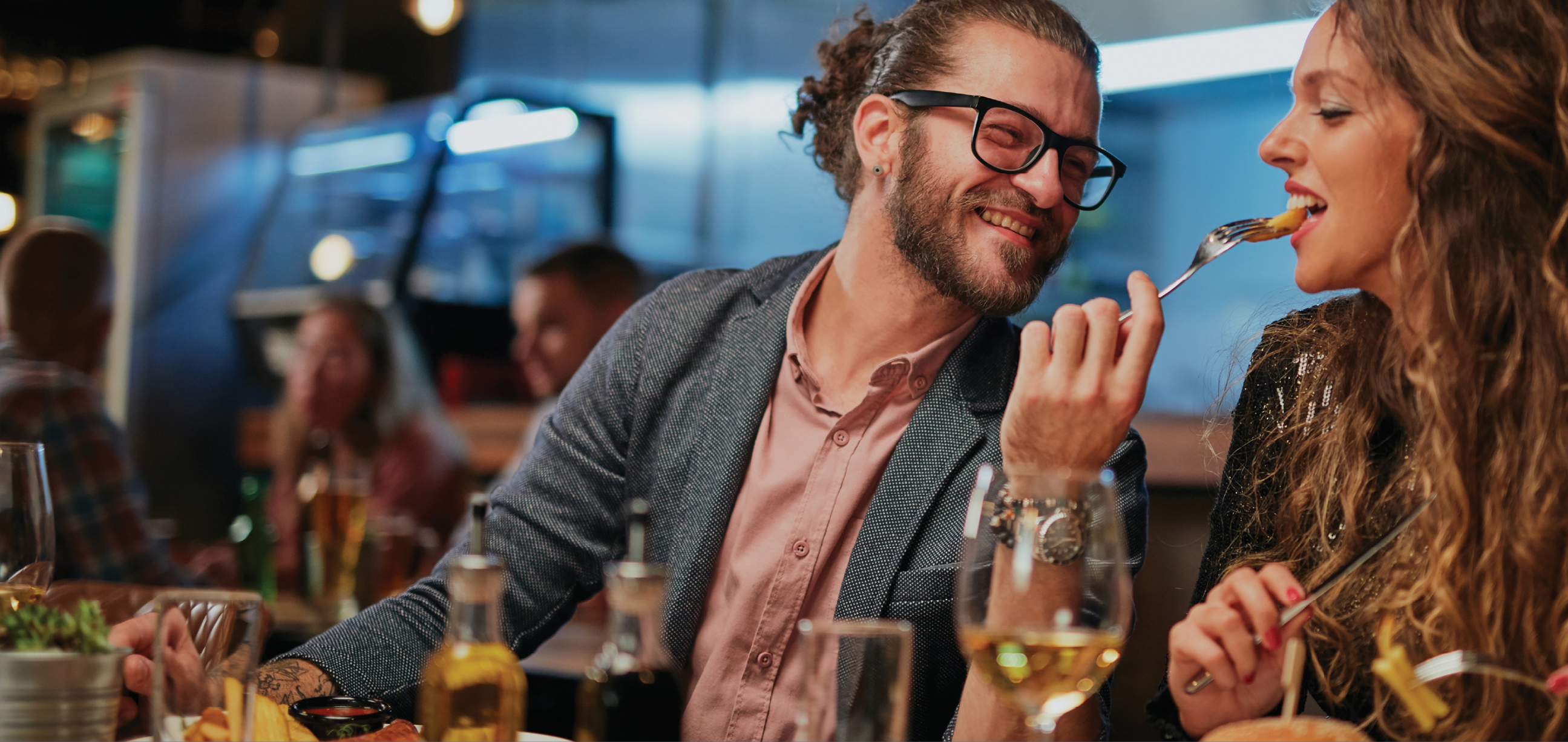 Friends sitting in restaurant and having dinner.