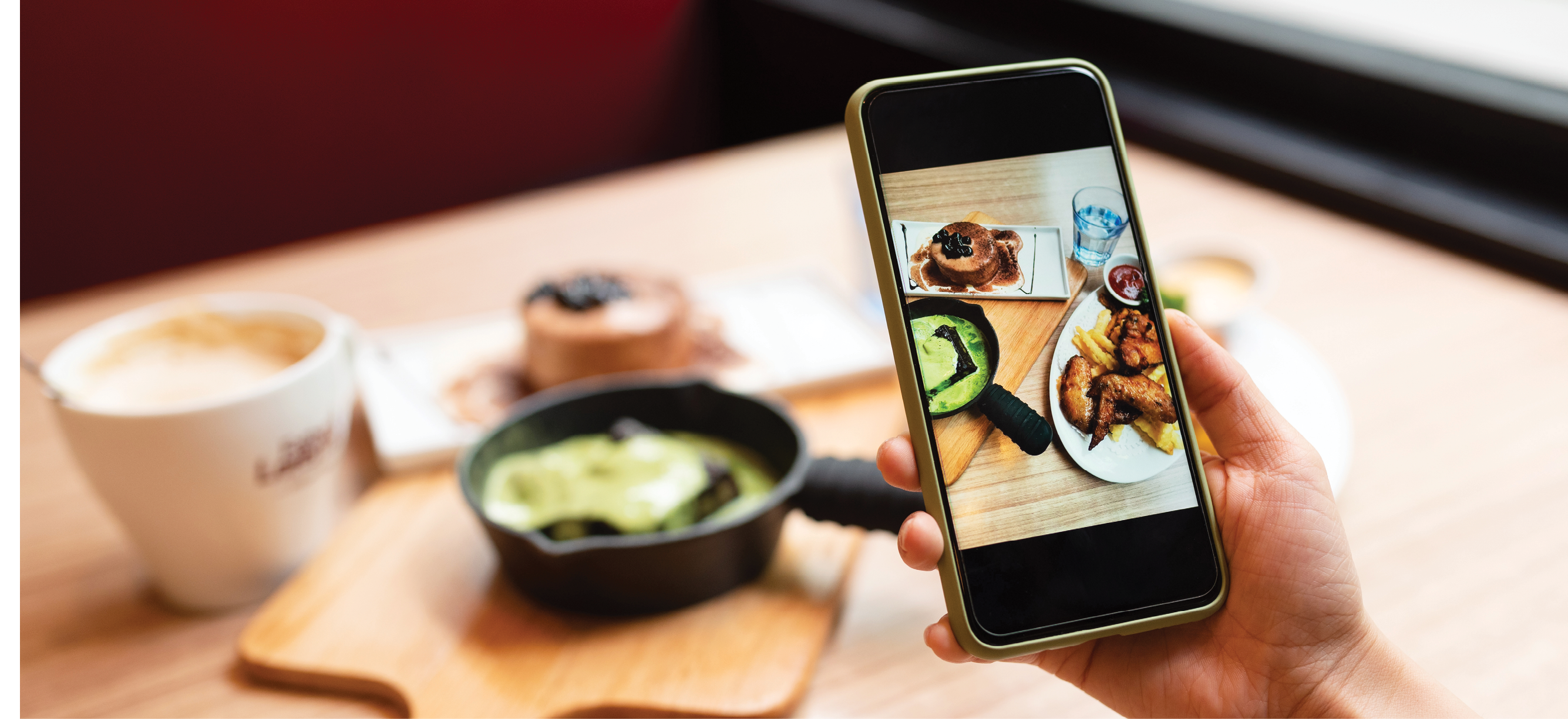 Woman's hand was taking photo of her food with smart phone.