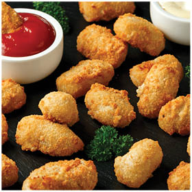 Crispy Battered scampi nuggets with ketchup and mayonnaise on rustic stone board