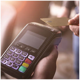 NFC credit card payment. Woman paying with contactless credit card with NFC technology. Wireless money transaction. Card machine in male hand on sunlight background