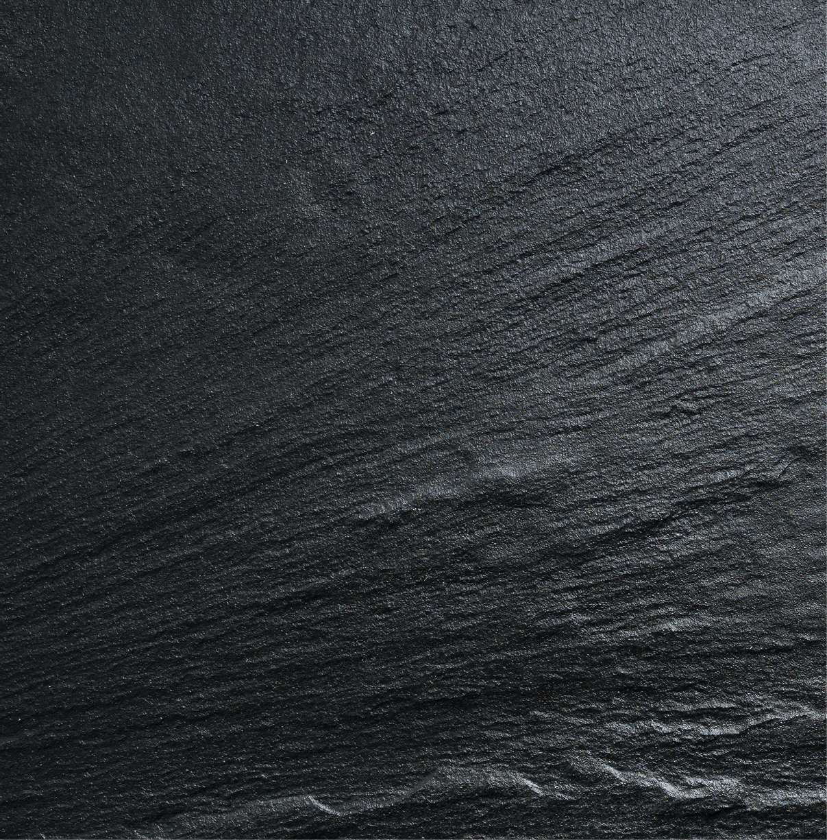 Dark grey / black slate texture, floortile, wallpaper or background. Rough texture with fine details.