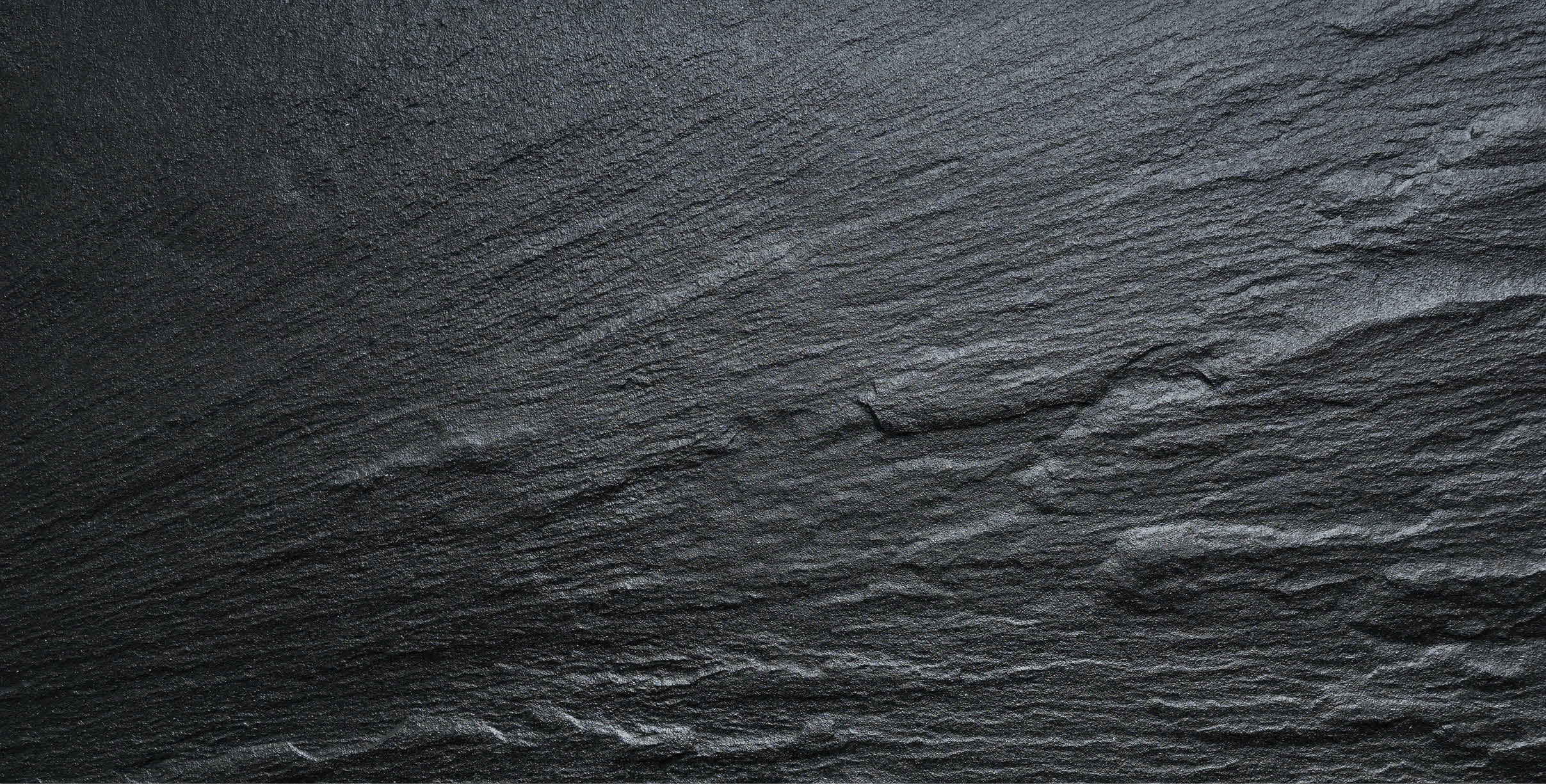 Dark grey / black slate texture, floortile, wallpaper or background. Rough texture with fine details.